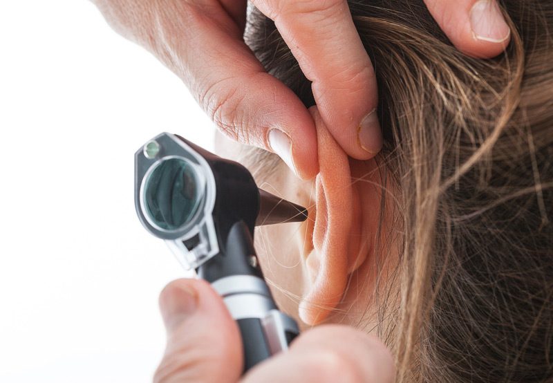 Closeup-of-examining-ear-with-an-otoscope