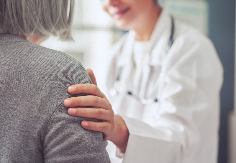 Doctor-comforting-patient-with-hand-on-shoulder