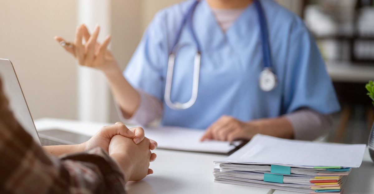 Doctor-consulting-with-patient-at-desk