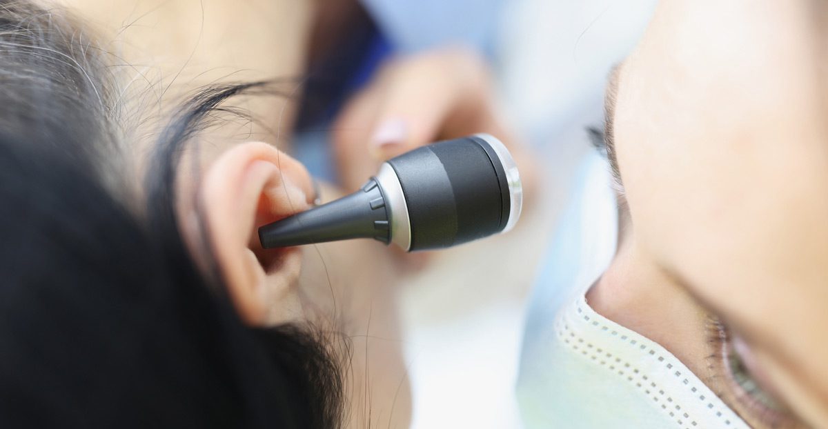 Doctor-examining-ear-with-otoscope