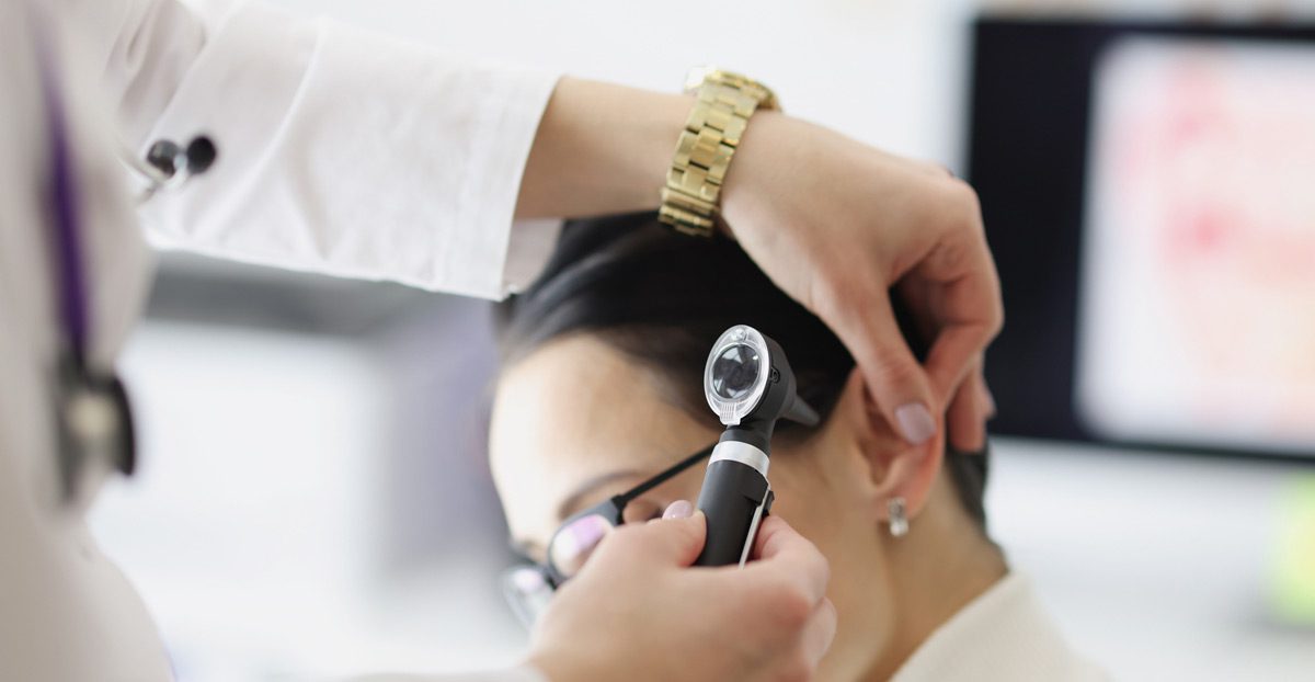 Doctor-examining-patient’s-ear-with-otoscope Doctor-examining-patient’s-ear-with-otoscope
