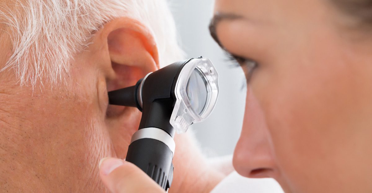 Doctor-examining-patient's-ear-with-otoscope Doctor-examining-patient's-ear-with-otoscope