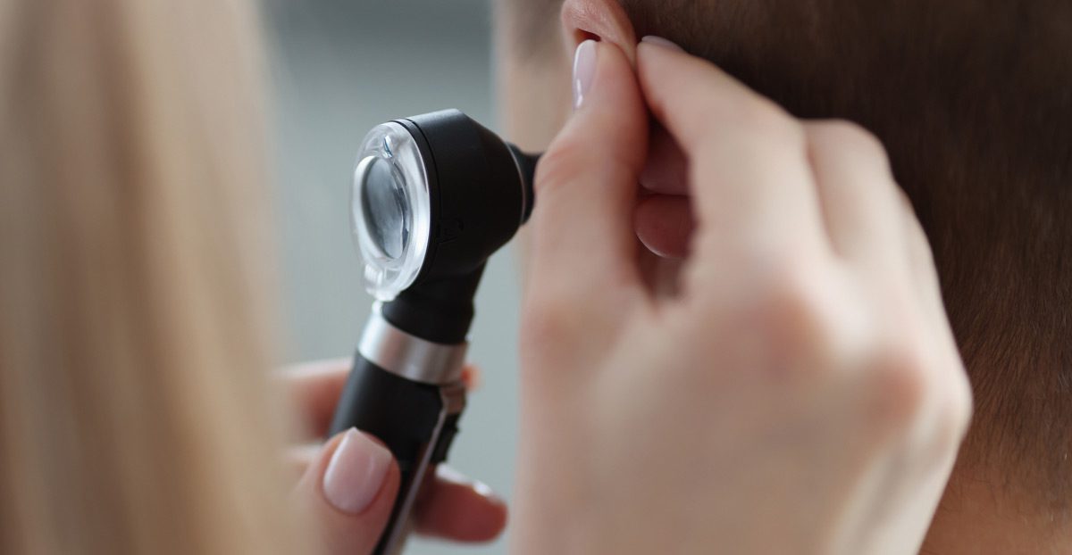 Doctor-examining-patient’s-ear-with-otoscope