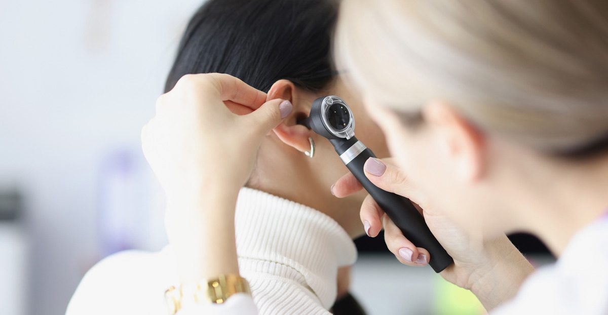Doctor-examining-patient’s-ear Doctor-examining-patient’s-ear