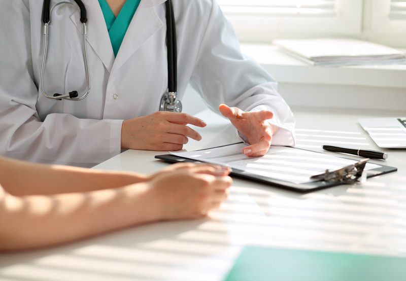 Doctor-explaining-medical-information-to-patient Patient-lying-inside-MRI-scanner